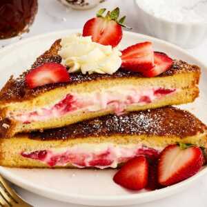 Stack of Strawberry Cream Cheese Stuffed French Toast slices.