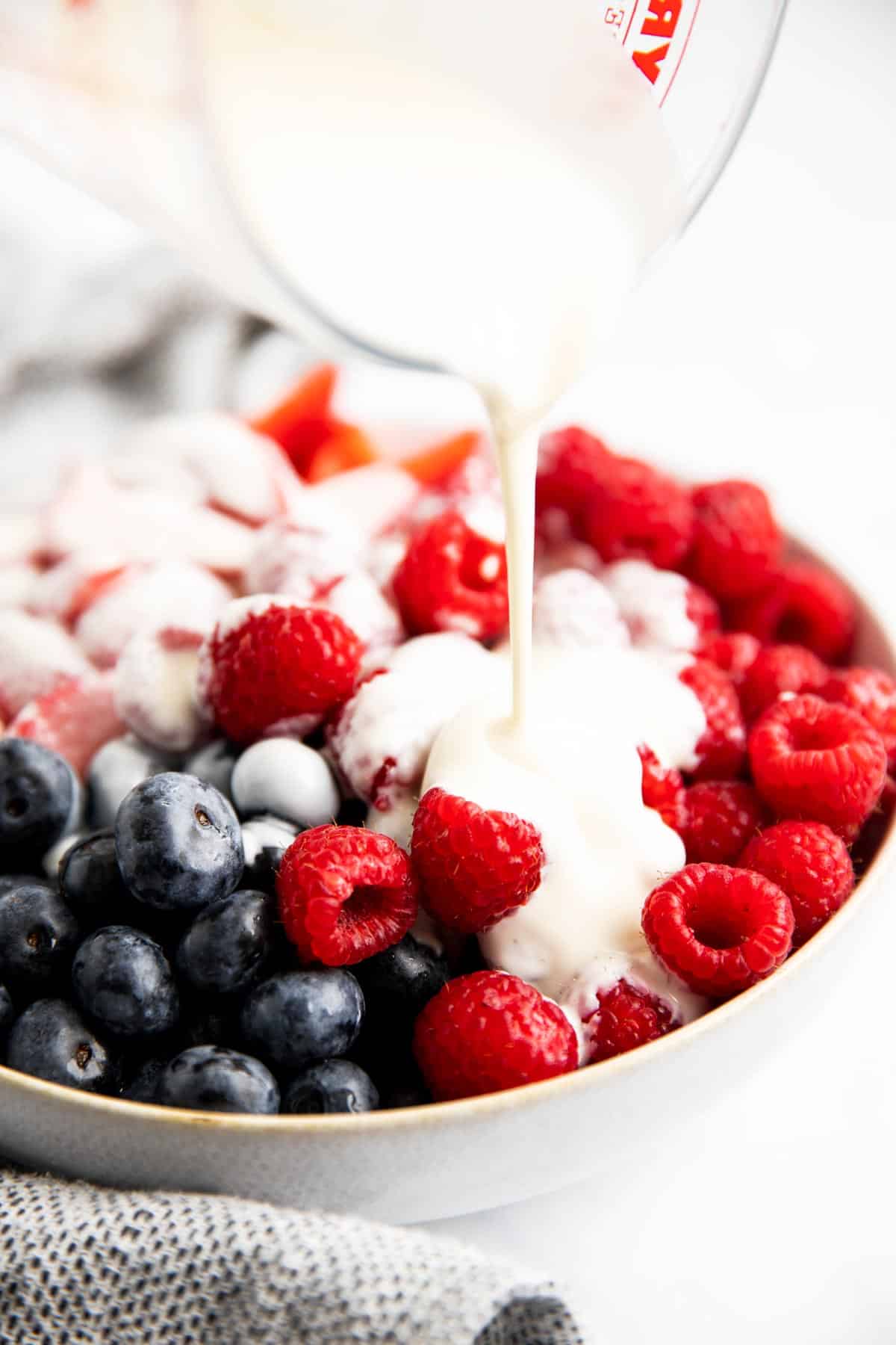 pouring dressing over berries