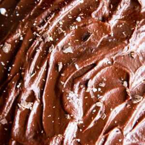 close up photo of chocolate ganache on a cake