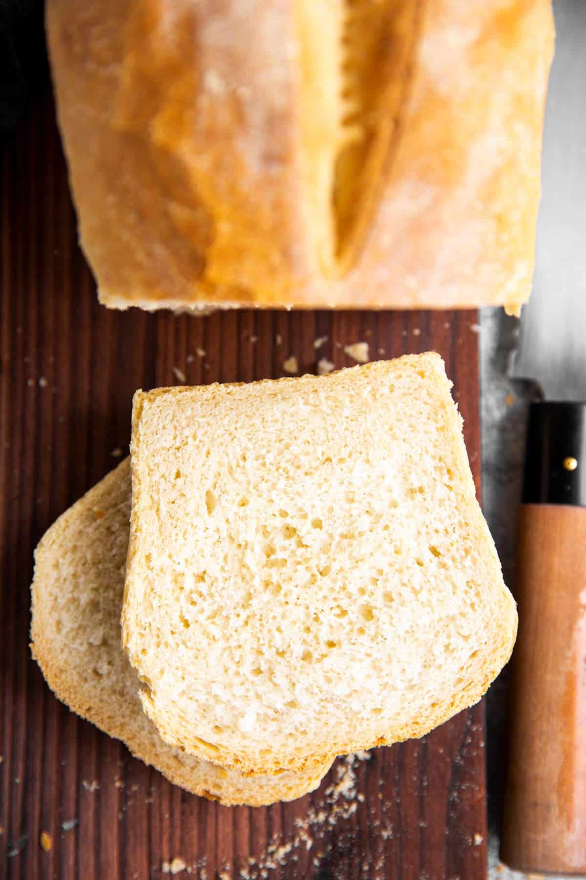 top down view on two slices of bread next to an unsliced loaf