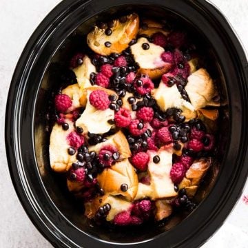 overhead view on raspberry French toast bake in black crockery dish