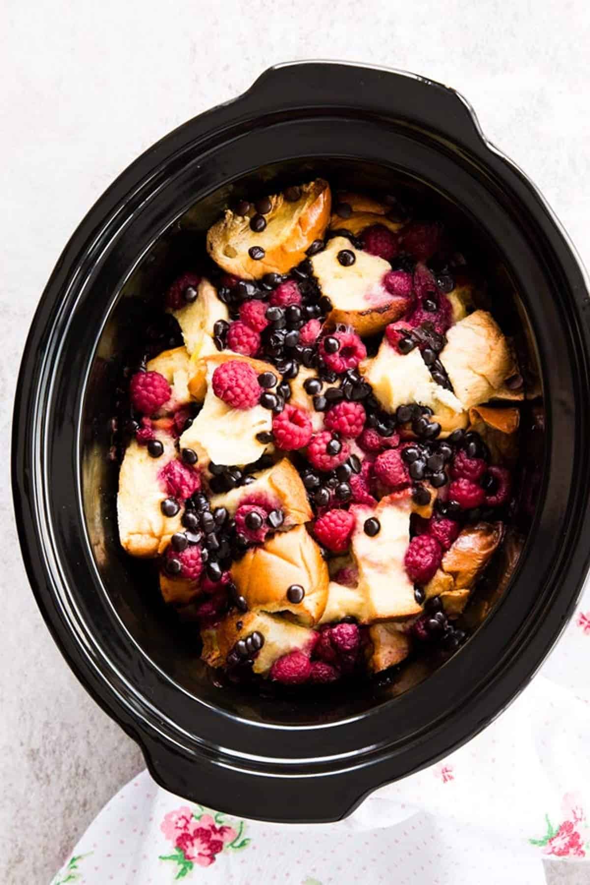 overhead view on raspberry French toast bake in black crockery dish