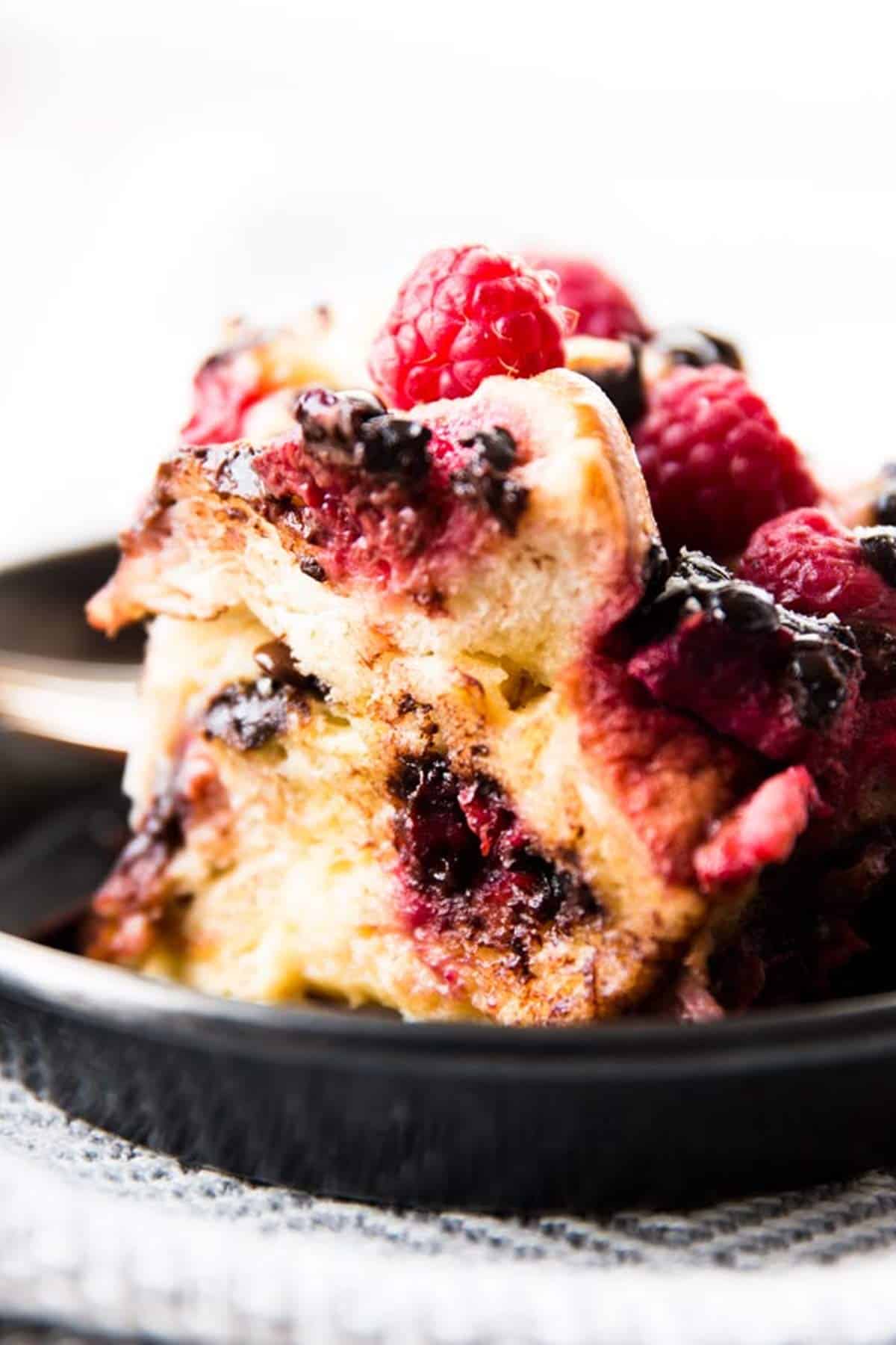slice of raspberry French toast casserole on black plate