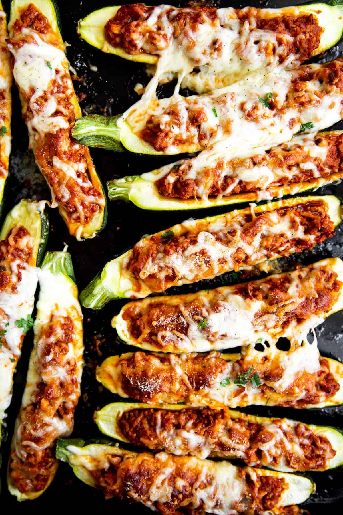 zucchini boats on a black pan