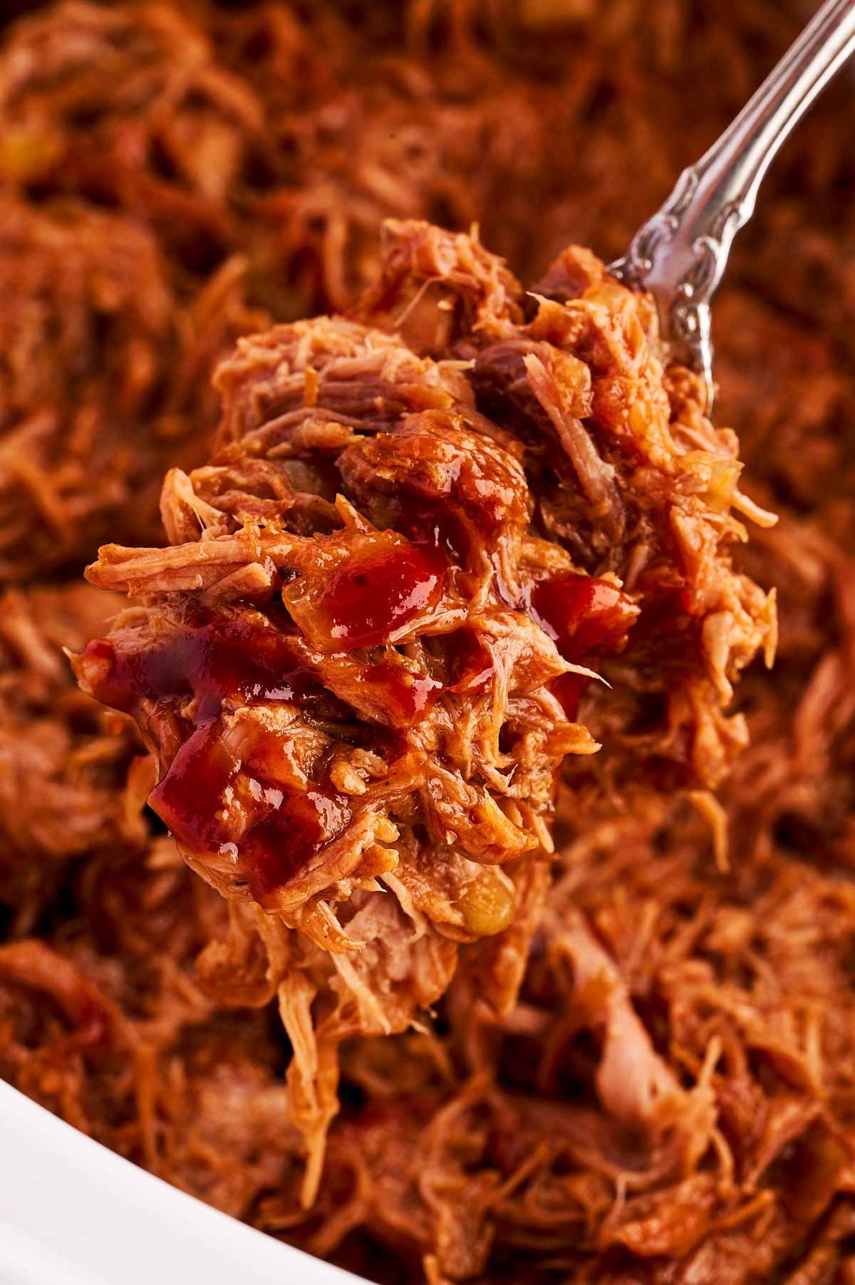 Close up of pulled pork on a fork.