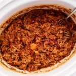 Pulled pork with BBQ sauce in crockpot.