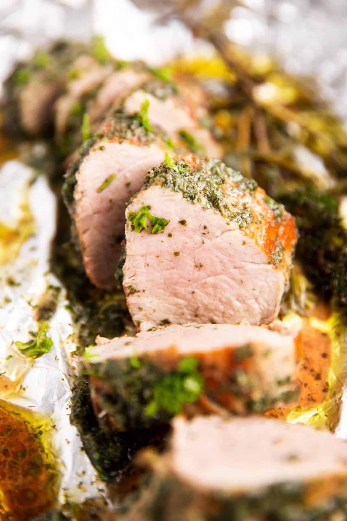 close up of sliced pork tenderloin in garlic herb butter