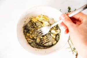 mashing compound butter with a fork