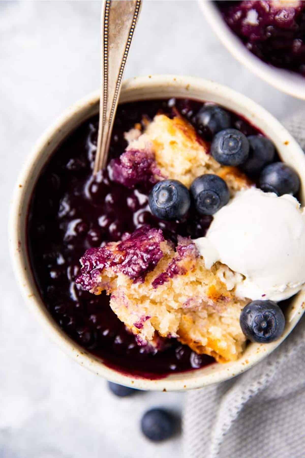 bowl with blueberry cobbler and ice cream