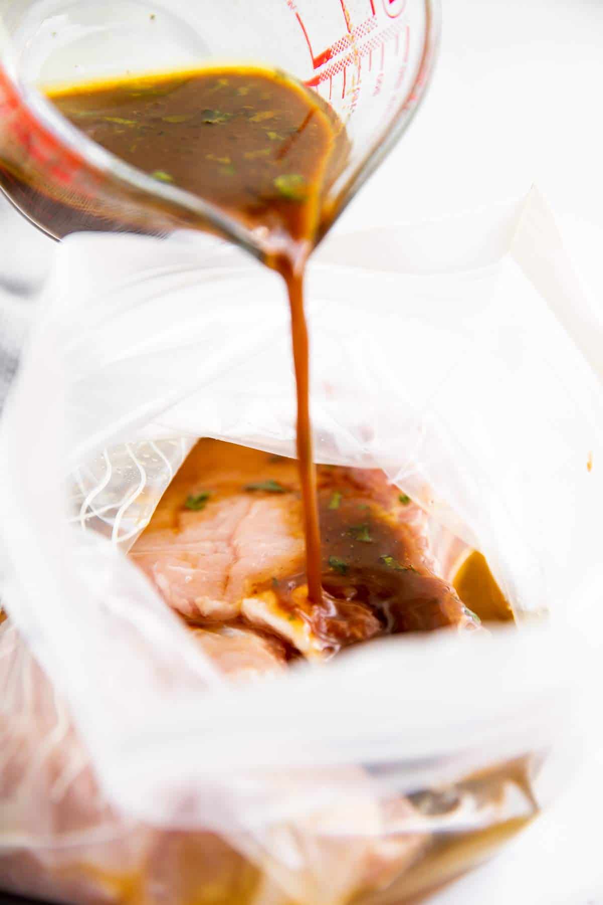 pouring marinade over pork chops