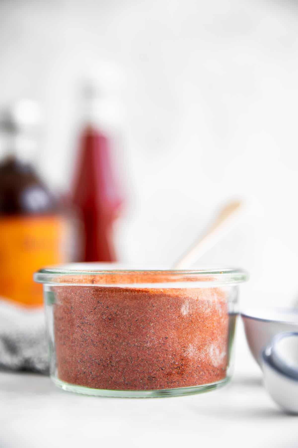 jar with bbq rub in front of condiment bottles