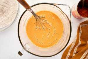 bowl with wet ingredients for pumpkin waffles