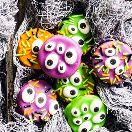 monster decorated Oreo cookies in fake spider webbing