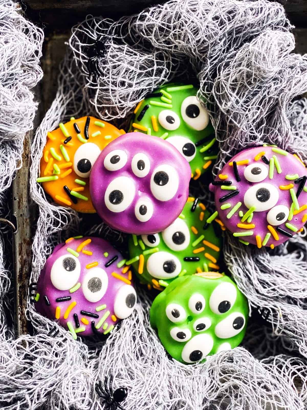 monster decorated Oreo cookies in fake spider webbing