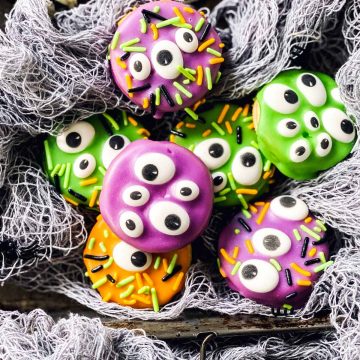 monster decorated Oreo cookies in fake spider webbing