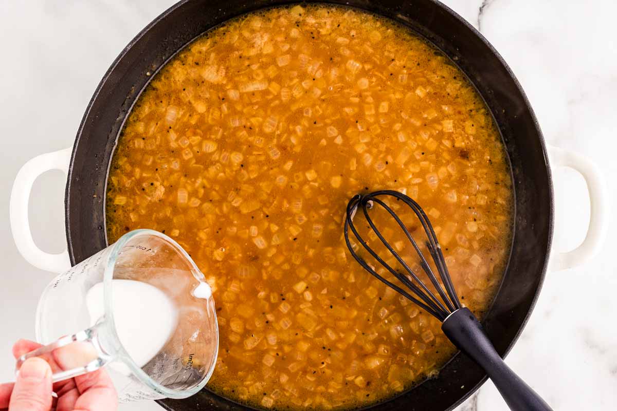 Thickening brown gravy with cornstarch slurry.