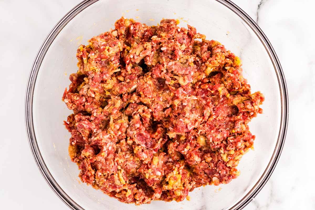 Mixture for meatballs in a glass bowl.