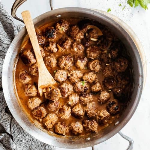 overhead view of skillet with meatballs in onion gravy