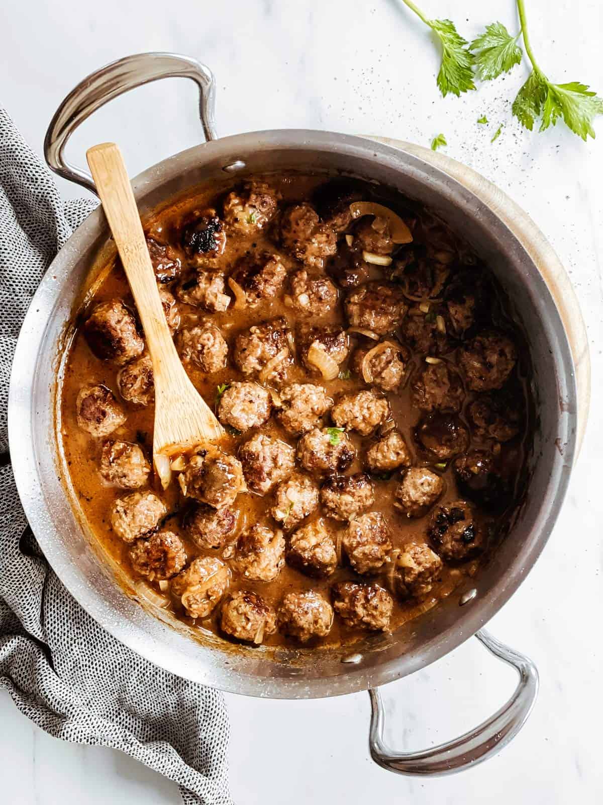 overhead view of skillet with meatballs in onion gravy