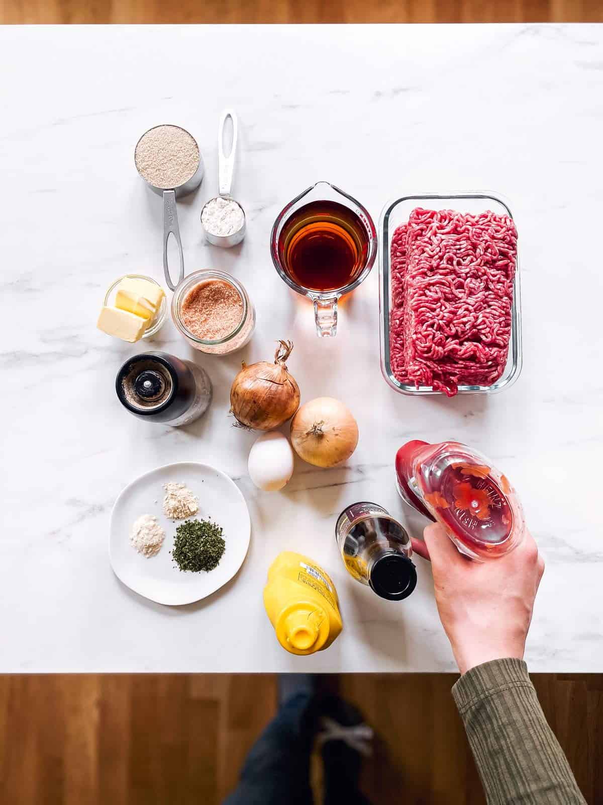 ingredients to make meatballs and gravy on a marble countertop