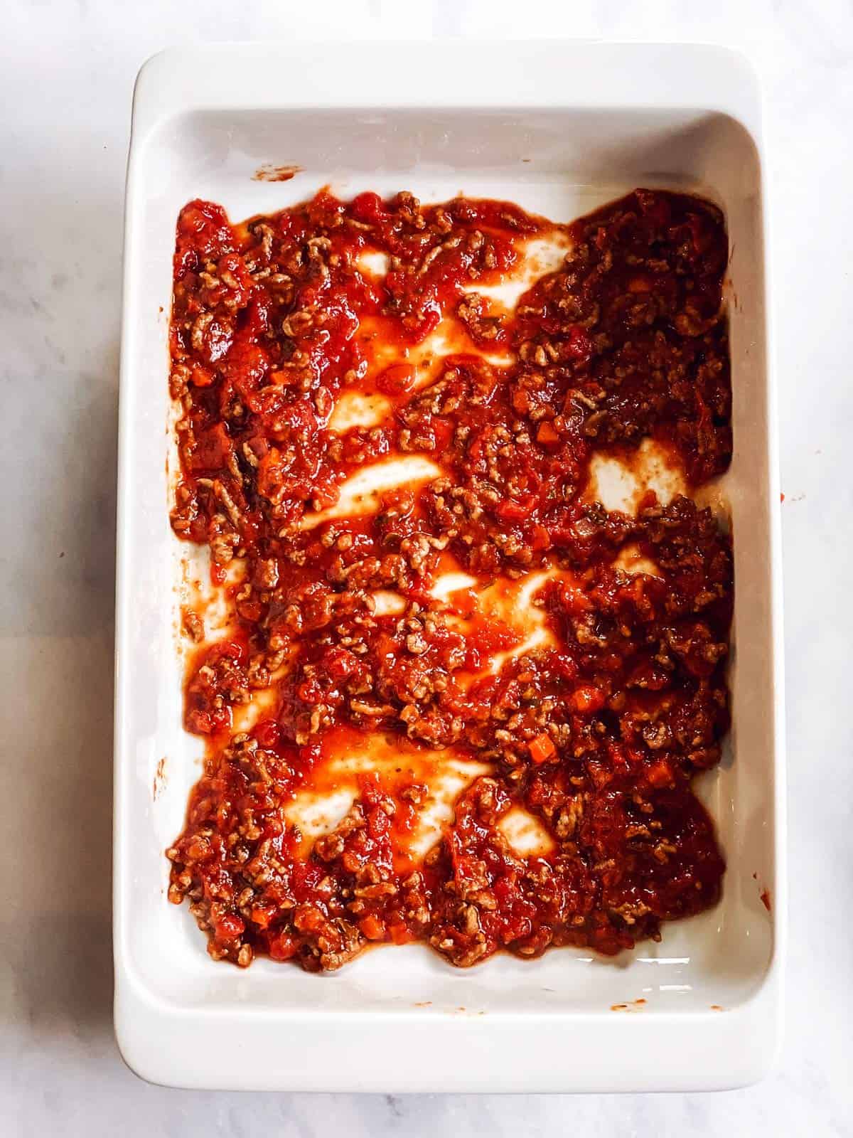 casserole dish with sauce at the bottom