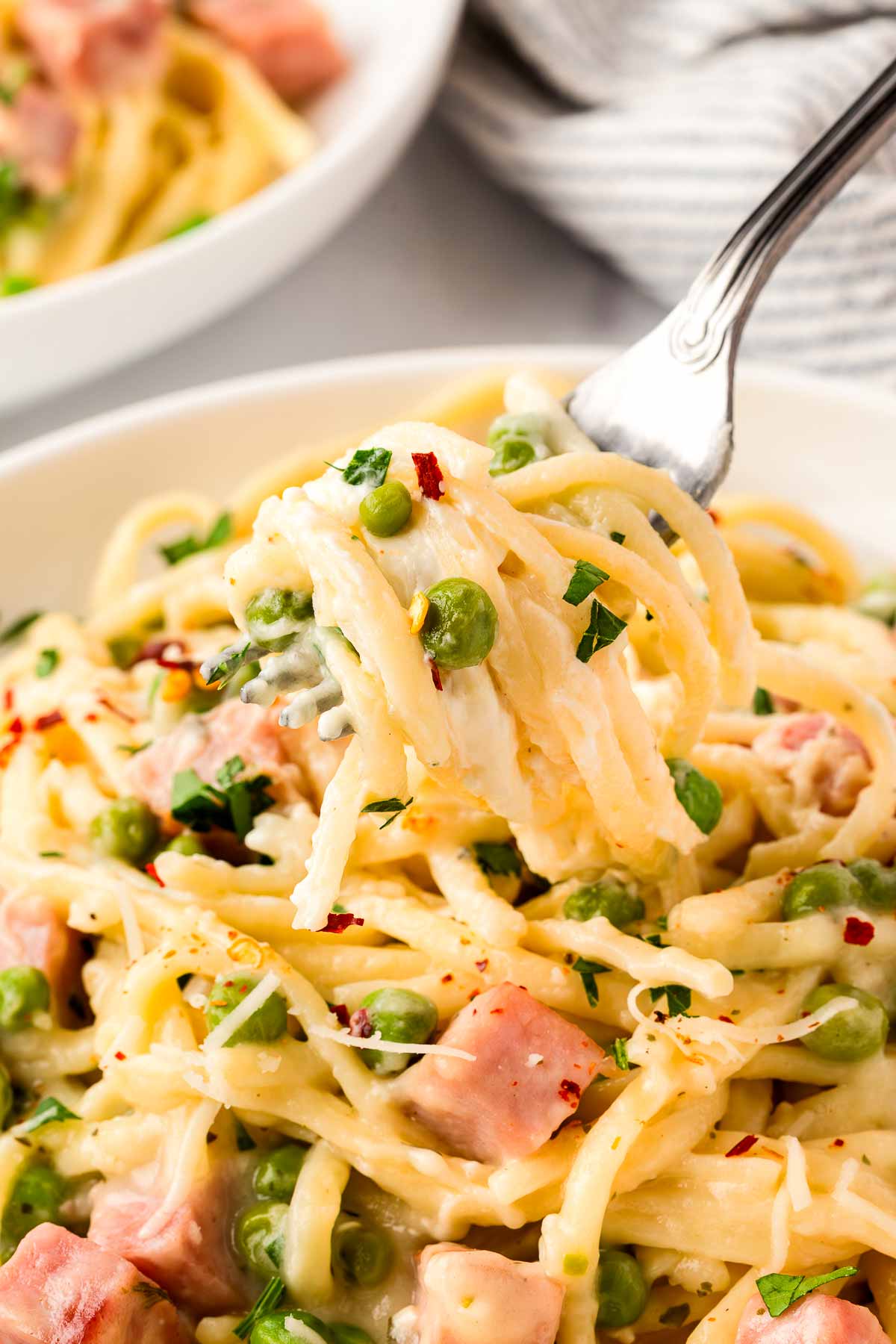 Pasta twirled on fork.