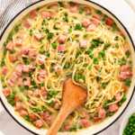 Serving a pot of ham and pea pasta.