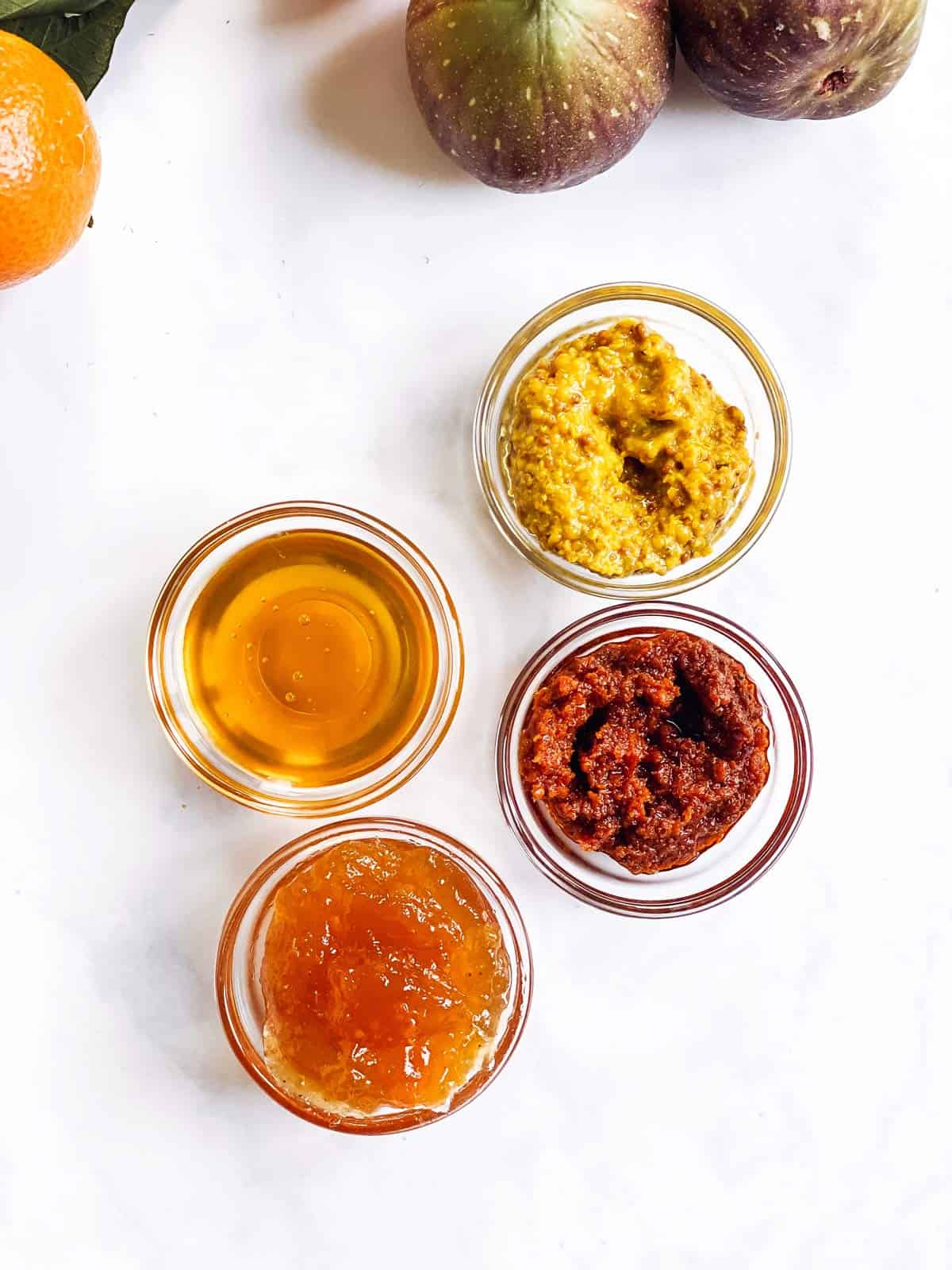 4 glass finger bowls with various dips and spreads