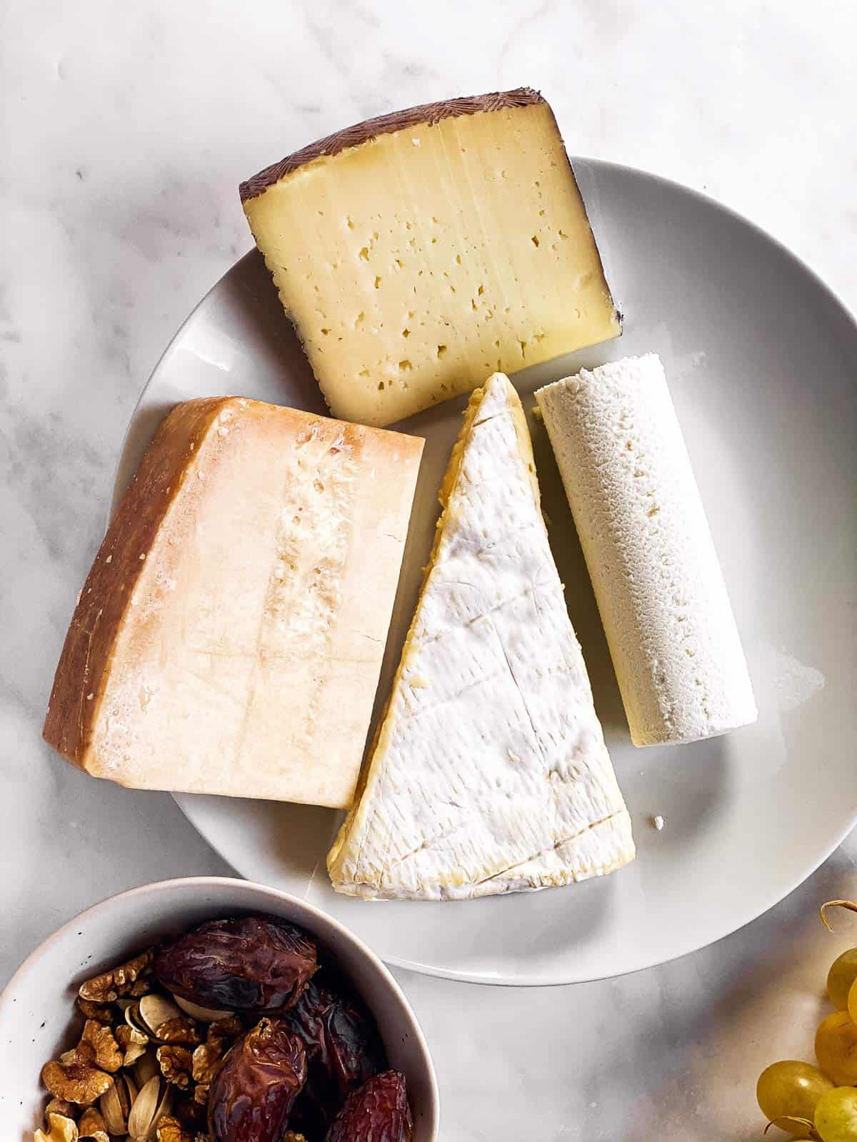 4 types of cheese on white plate