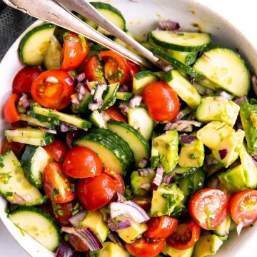 white bowl with tomato cucumber avocado salad