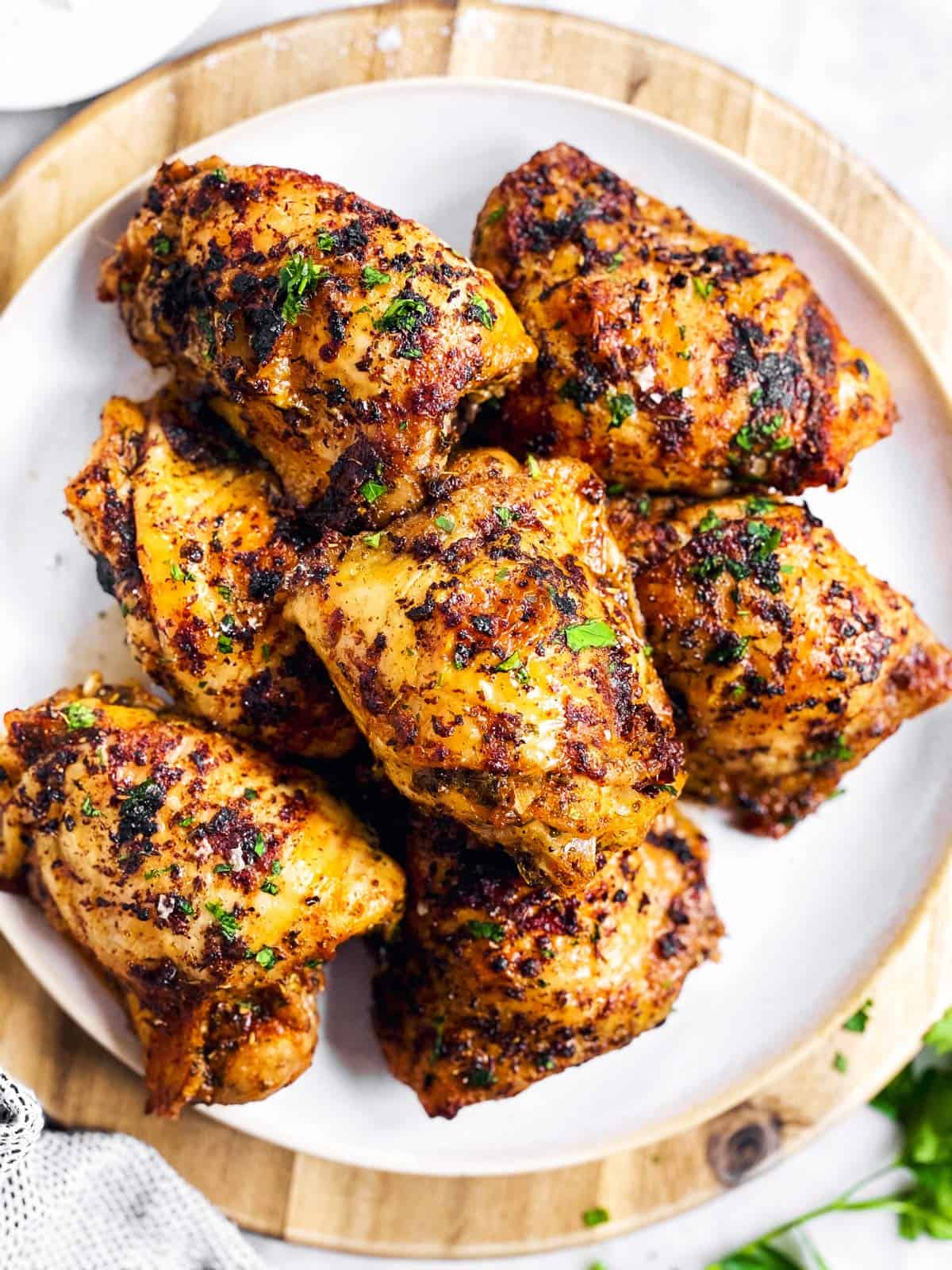 close up photo of baked chicken thighs on plate