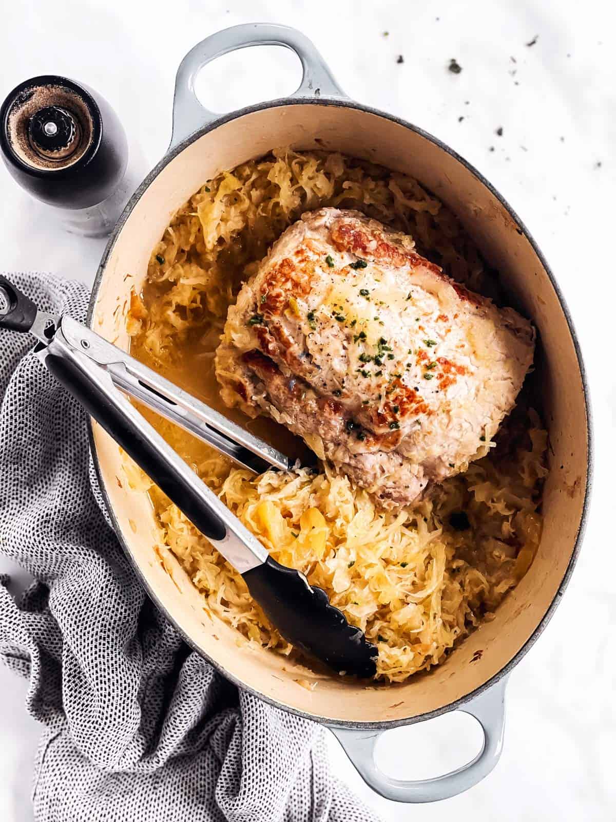 overhead view of Dutch oven with cooked pork and sauerkraut