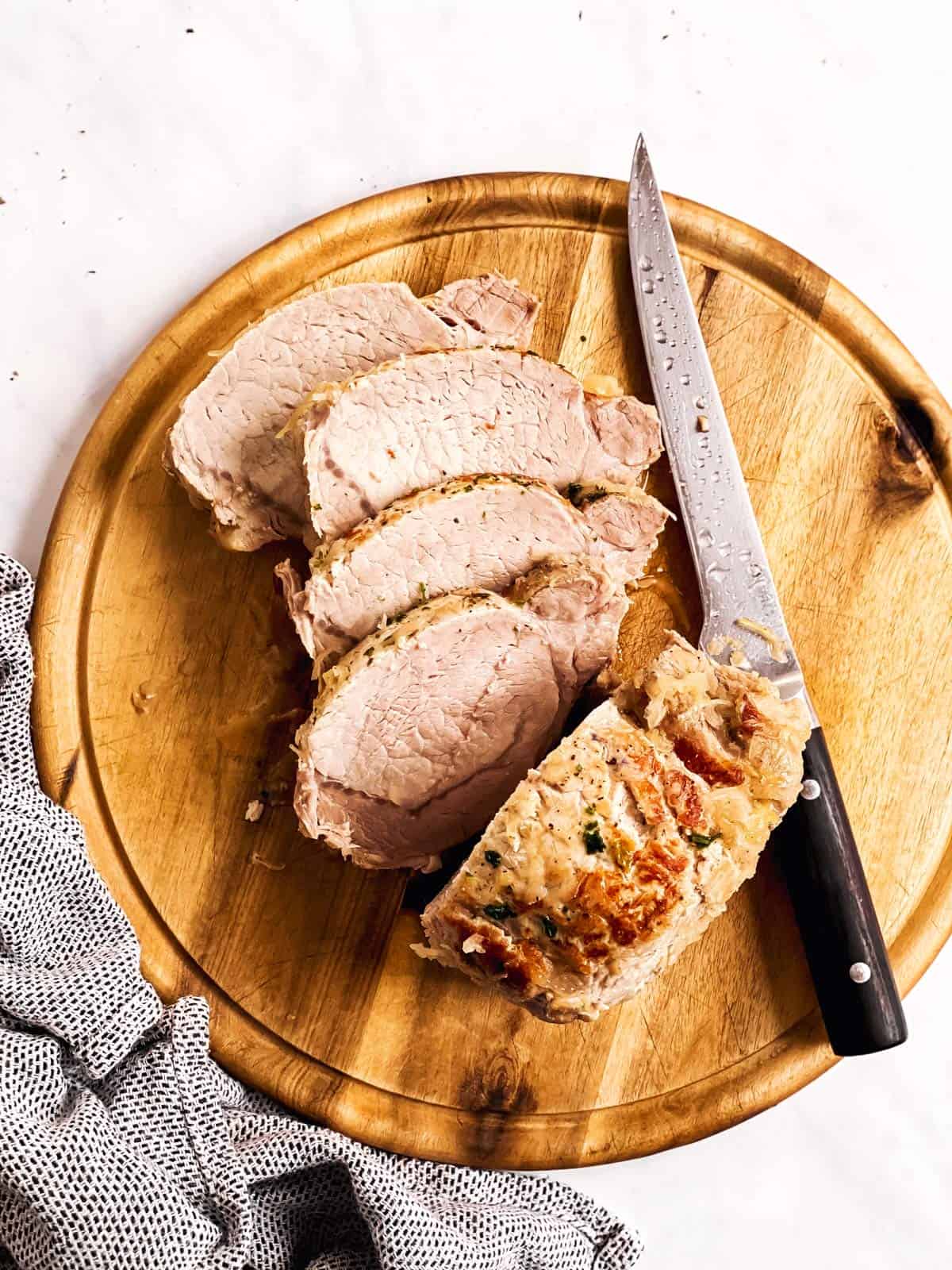 sliced pork and sauerkraut on wooden board