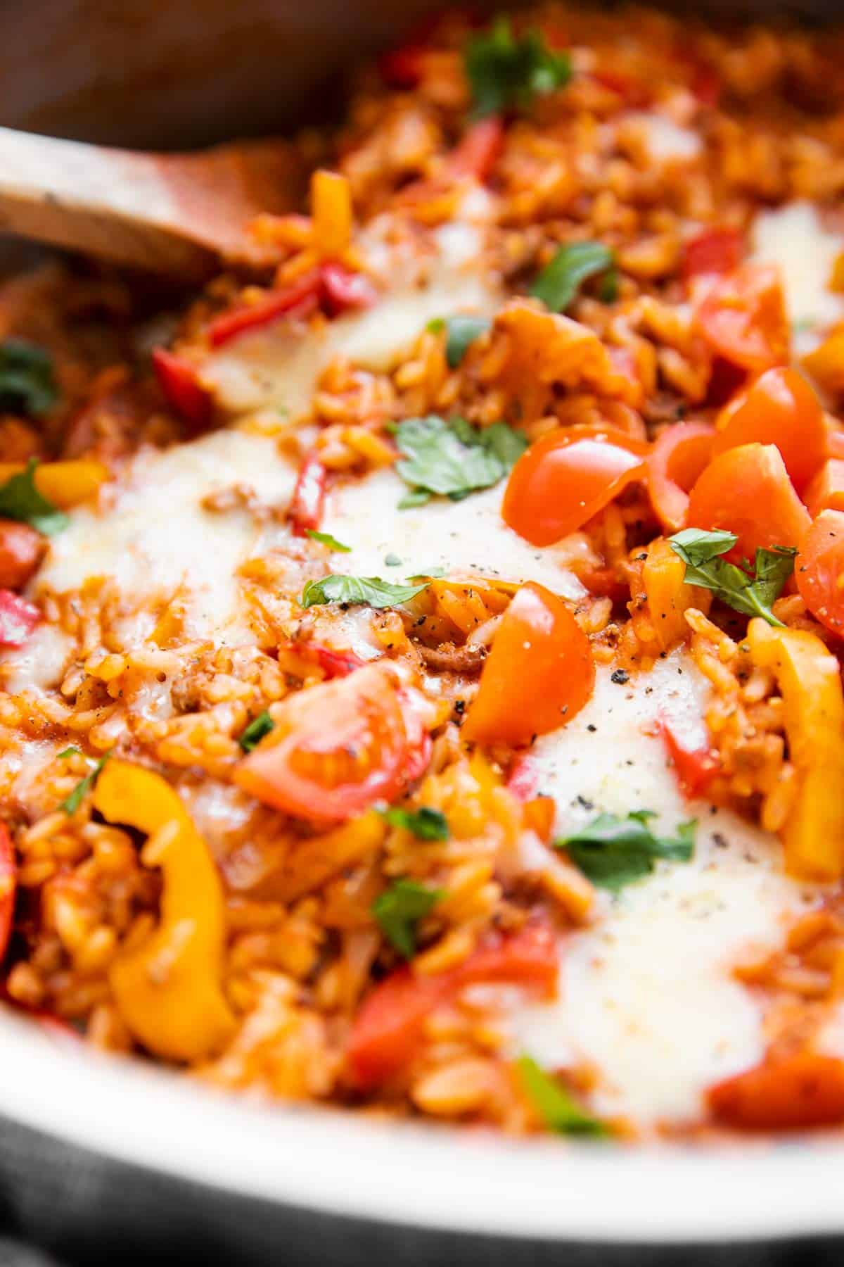 close up photo of melted cheese on top of unstuffed peppers