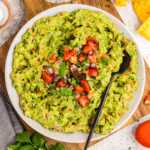 Serving guacamole in a bowl with chips.