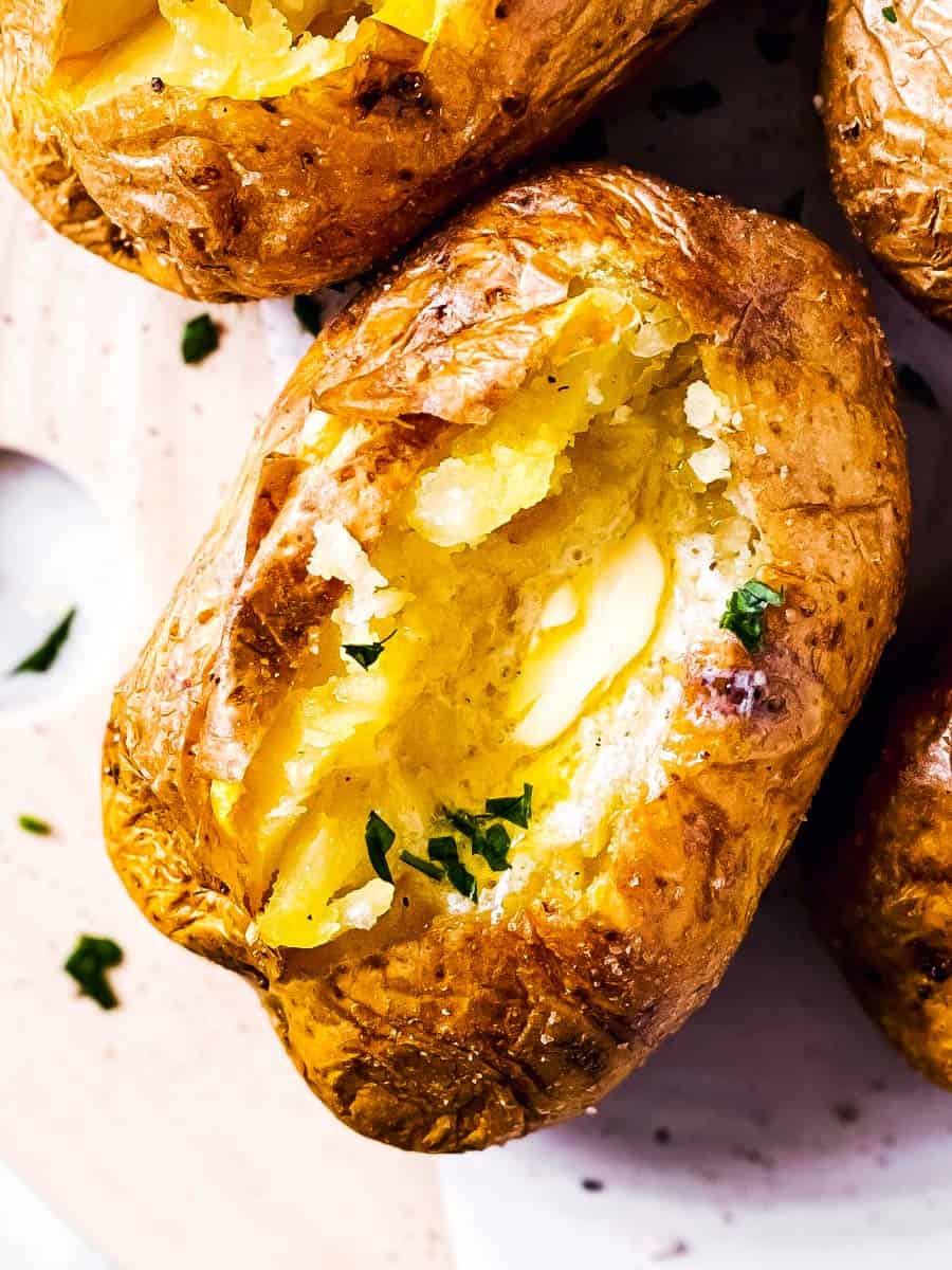 close up photo of air fryer baked potato with butter