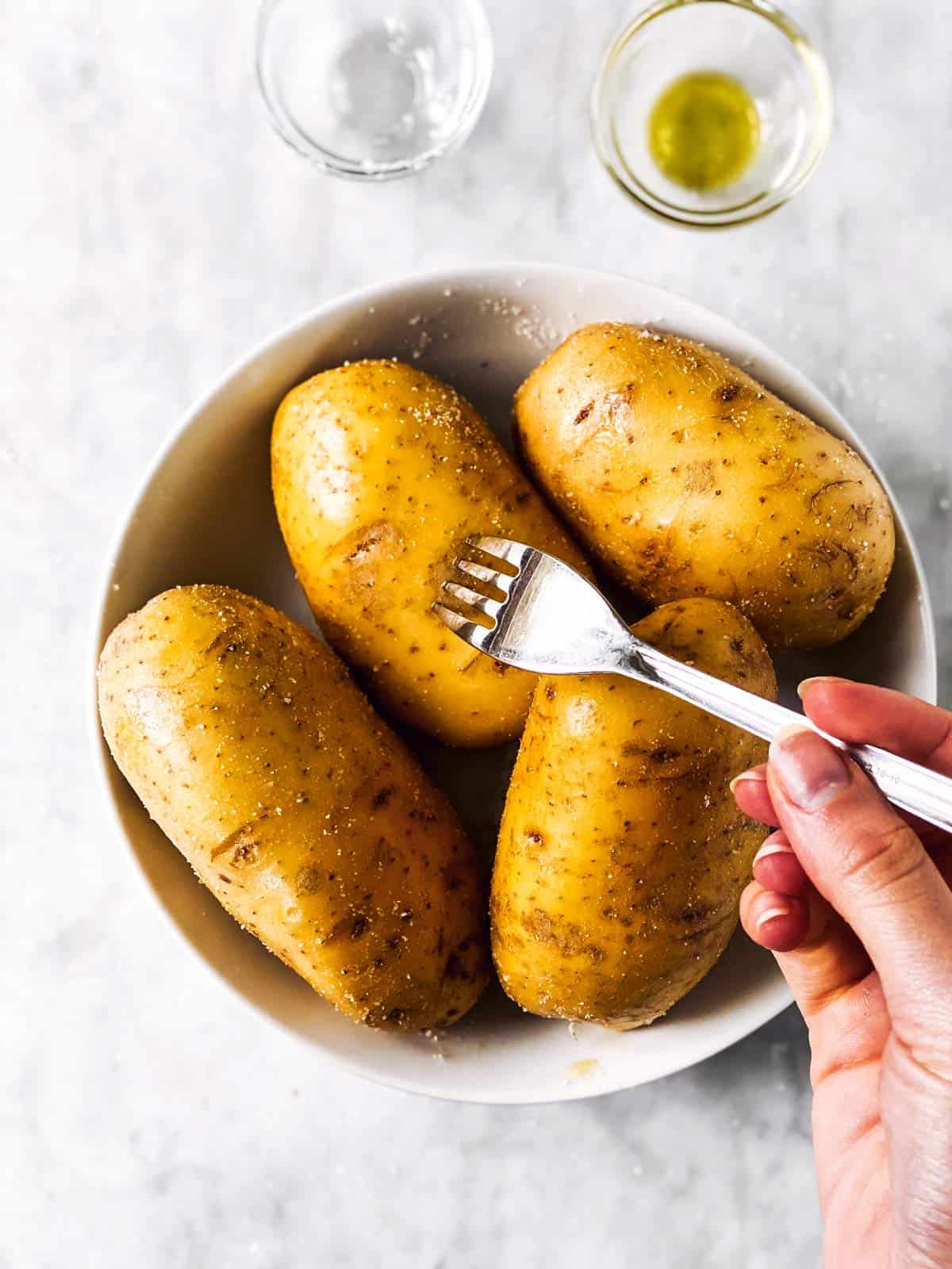 fork pricking a russet potato