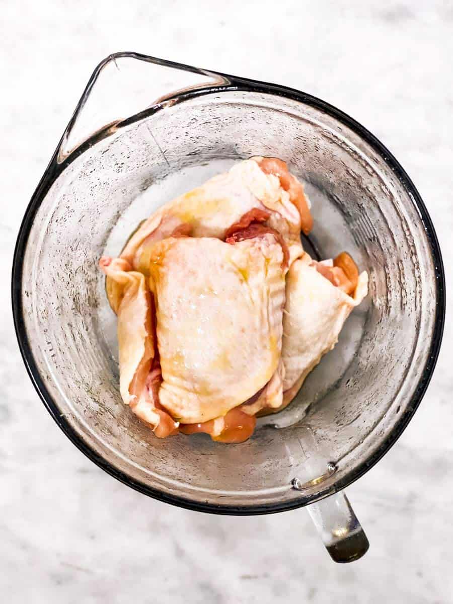 glass bowl with chicken thighs