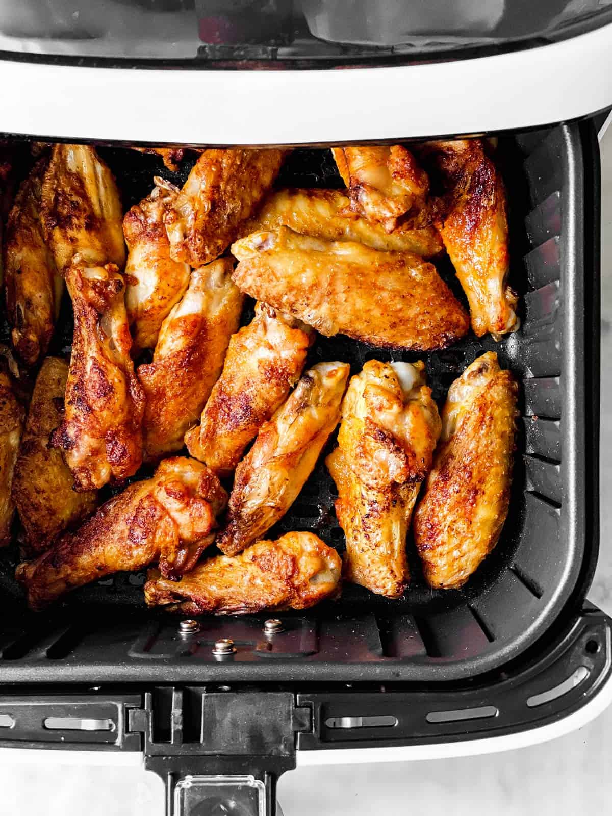 cooked chicken wings in air fryer basket