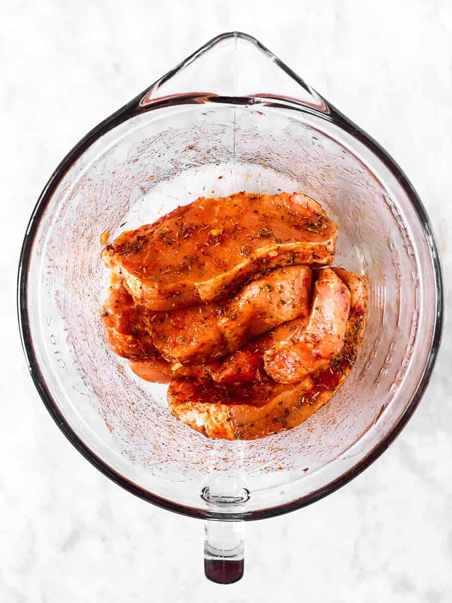 seasoned pork chops in glass bowl