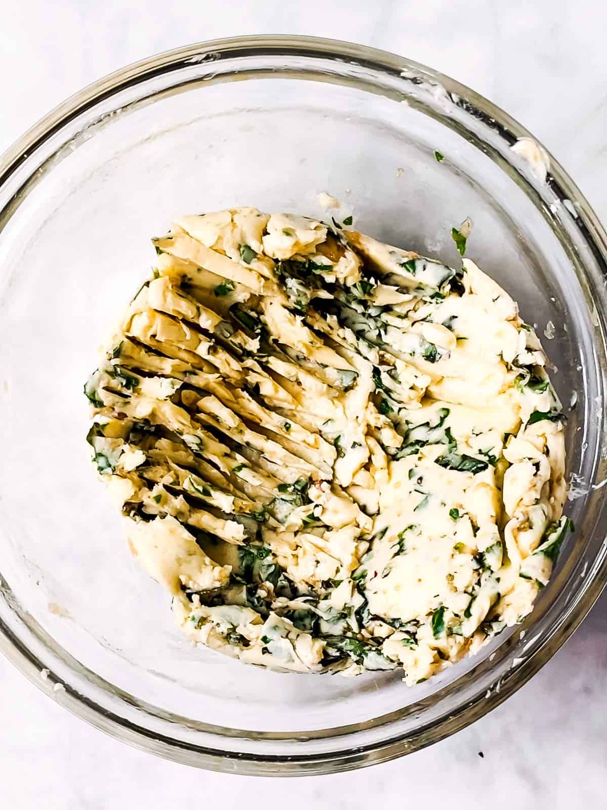 glass bowl with garlic herb butter