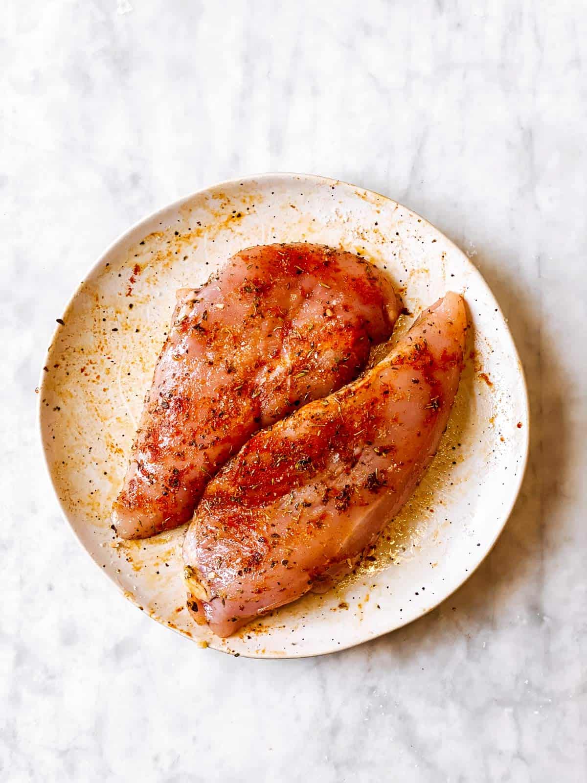 seasoned chicken breasts on white plate