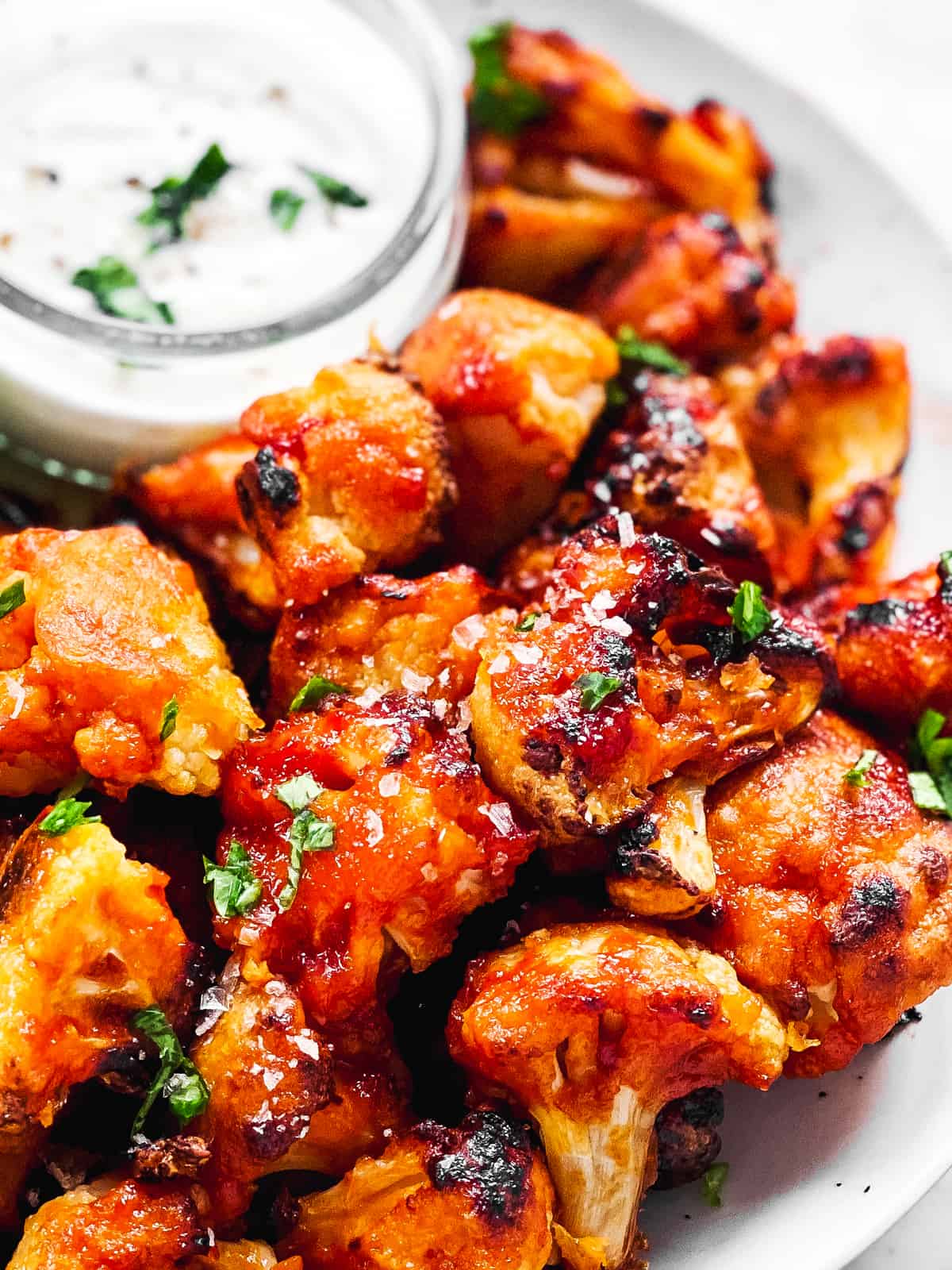 close up photo of piled up buffalo cauliflower wings