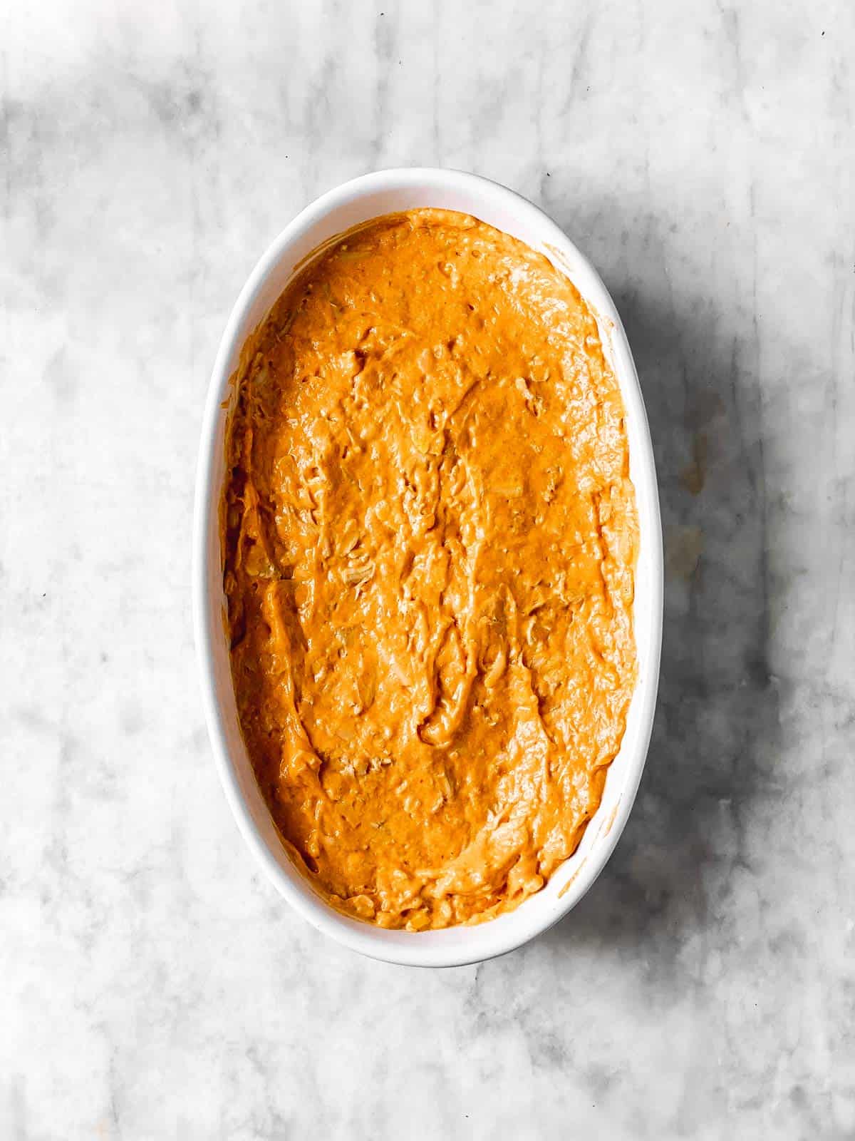 casserole dish with buffalo chicken dip mixture