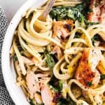 close up photo of creamy salmon pasta in white bowl