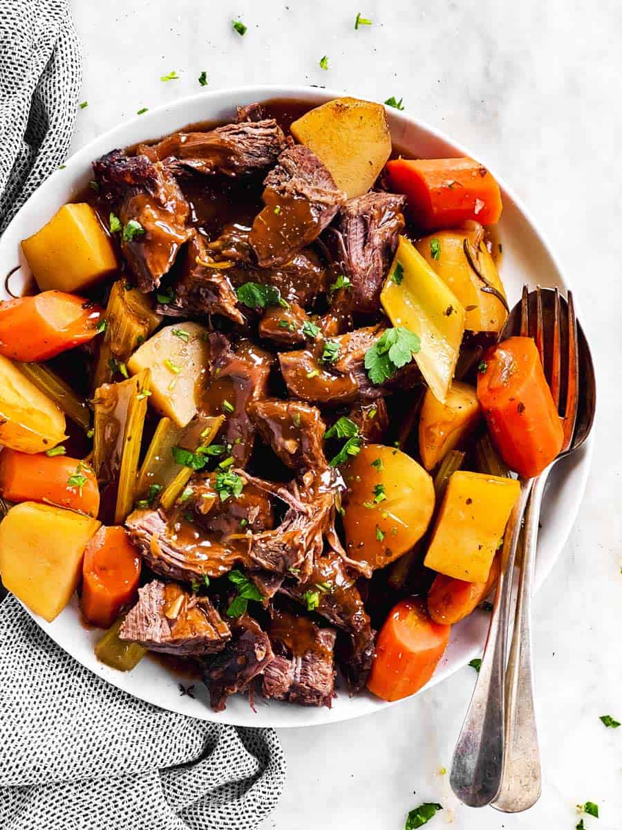 white serving platter with slow cooker pot roast