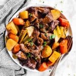 overhead view of white platter filled with pot roast