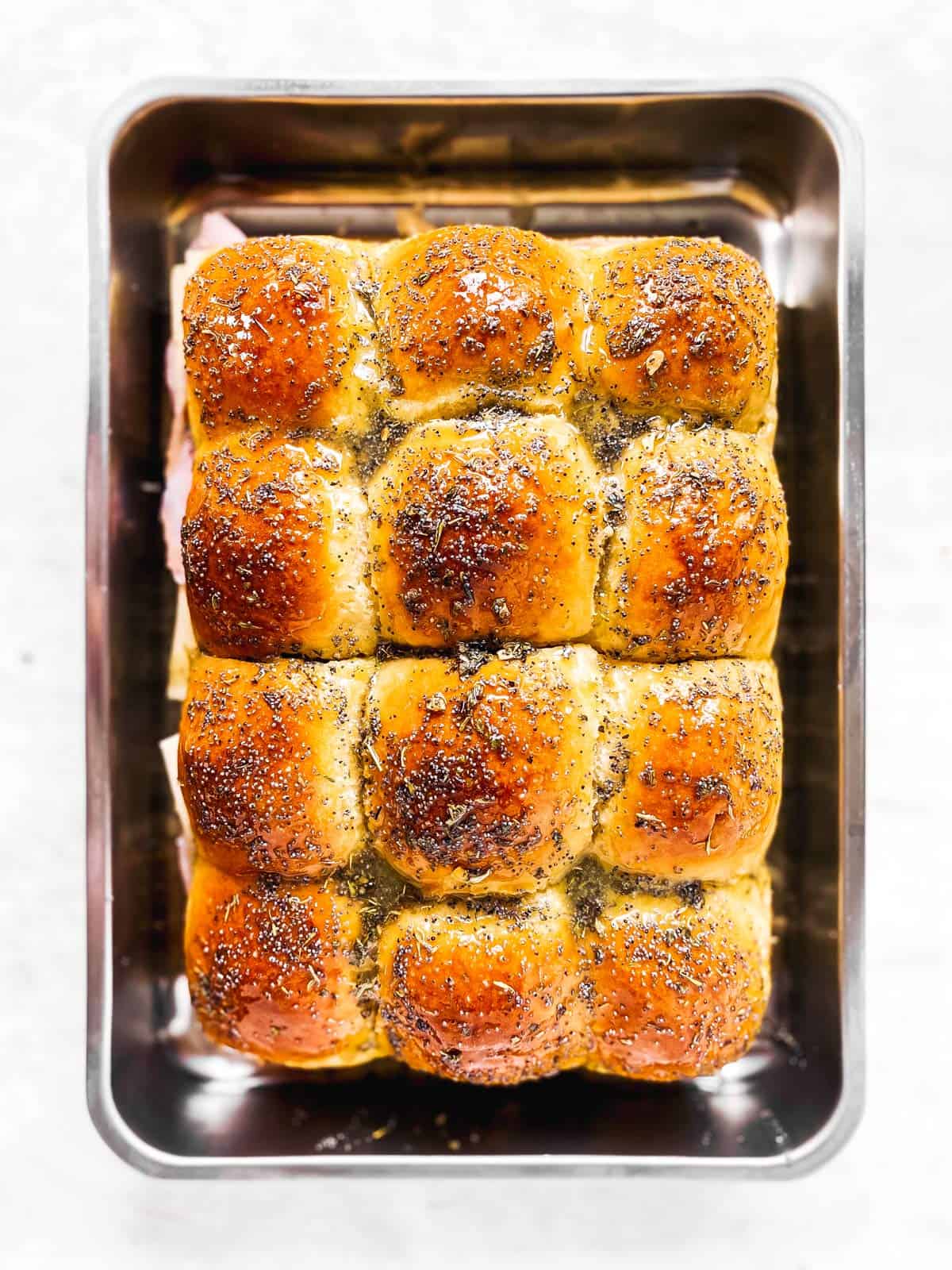 dinner rolls topped with poppy seeds and dried herbs