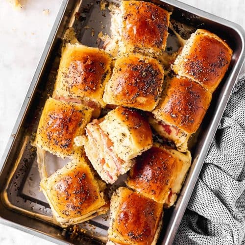 tray with hot ham sliders on marble surface