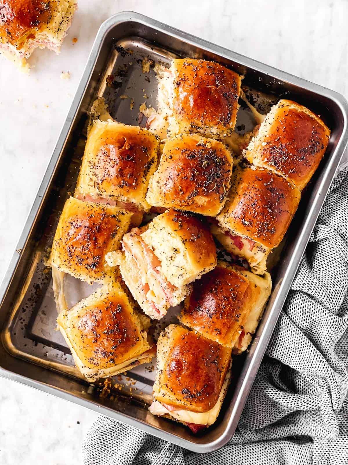 tray with hot ham sliders on marble surface